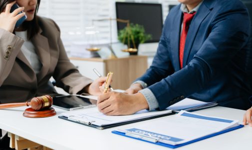 business people and lawyers discussing contract papers sitting at the table. Concepts of law, advice, legal services. in morning light